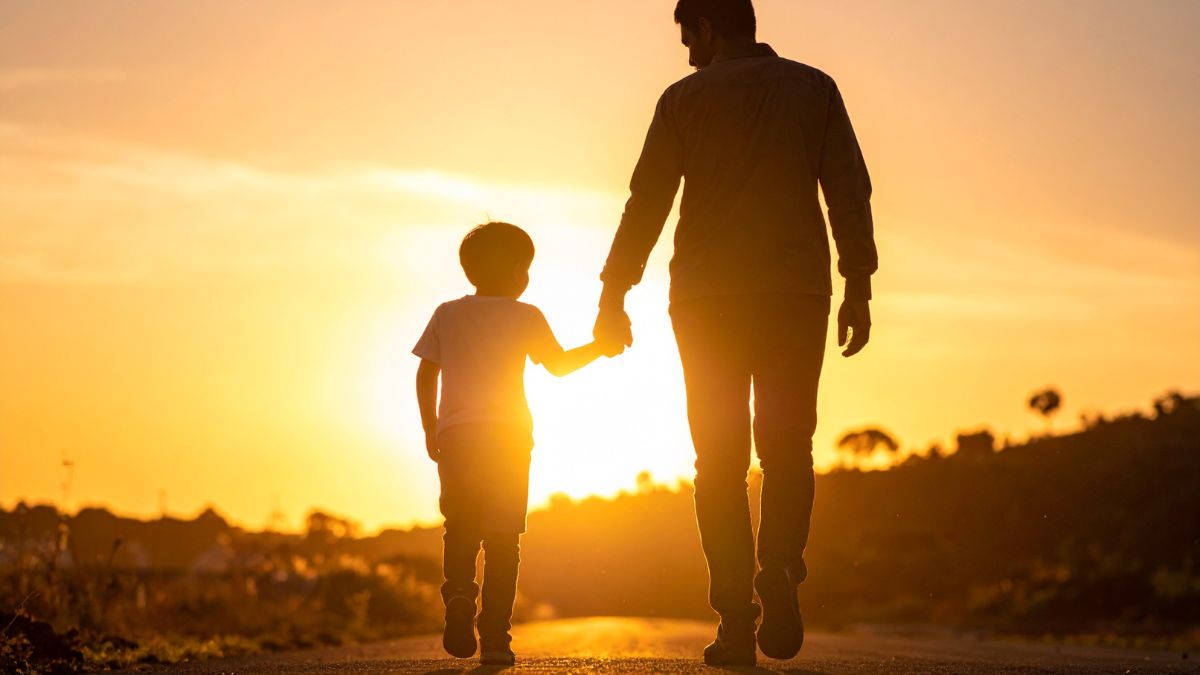 Spermatogenesis and male fertility: father and child walking together at sunset